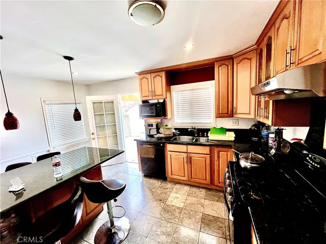 a kitchen with a sink stove and cabinets
