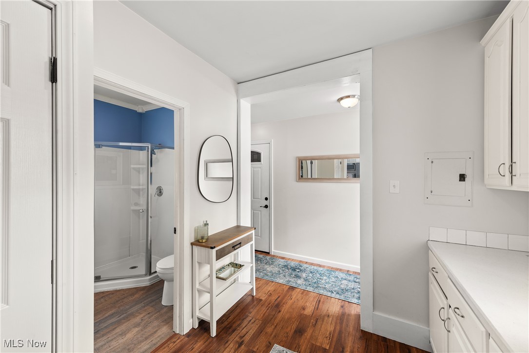 8767 Edgehill Road Mentor, OH 44060 - Photo 6 of 47 Bathroom with hardwood / wood-style floors, toilet, vanity, and a shower with door