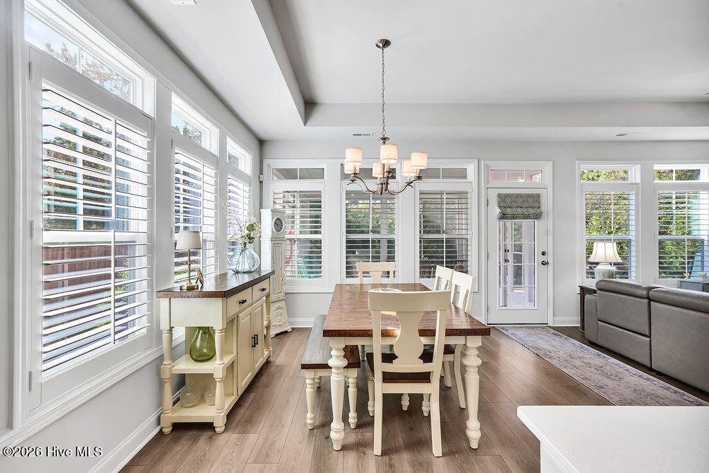 142 Rice Marsh Way Wilmington, NC 28412 - Photo 19 of 64 The dining area is absolutely drenched in sunlight thanks to a bank of large, energy-efficient Low-E windows. Outfitted with custom plantation blinds, these windows allow for an easy transition between indoor and outdoor spaces and add an air of southern coastal charm to the neutral Scandi-meets-seaside color palette.
