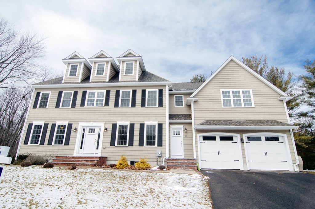 a view of a white house with large windows
