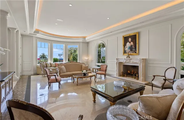a living room with furniture fireplace and a window