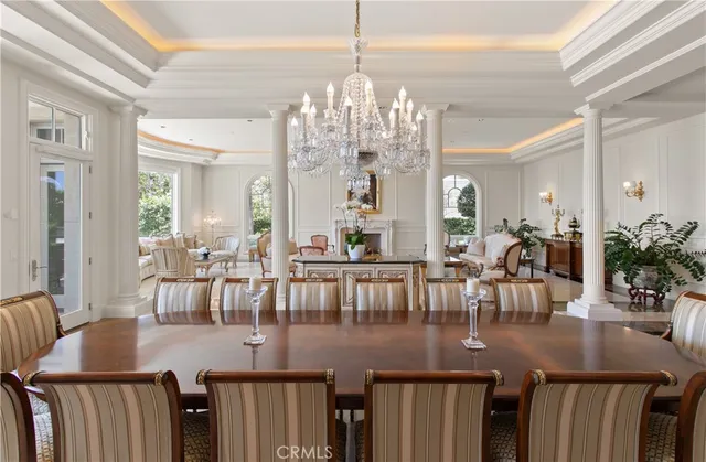 a view of a dining room with furniture a chandelier and wooden floor