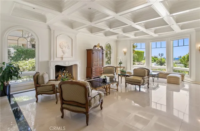 a living room with furniture fireplace and a large window