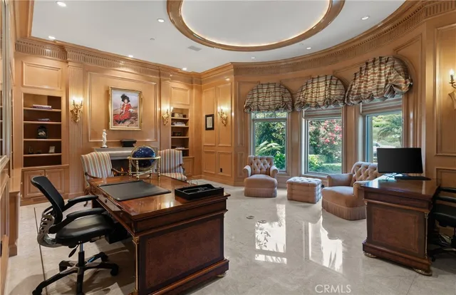 a work room with furniture and large windows