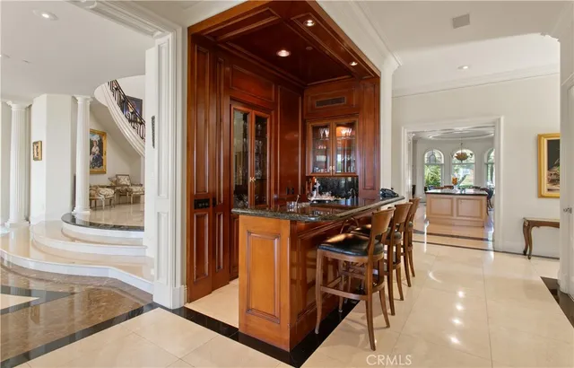 a view of a dining room with furniture and a chandelier