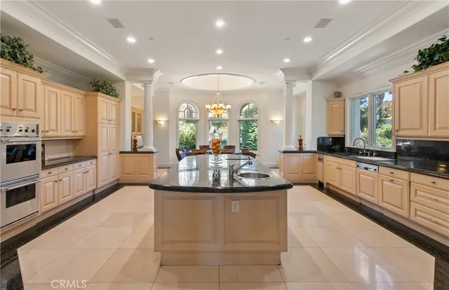 a large kitchen with stainless steel appliances lots of counter space and a sink