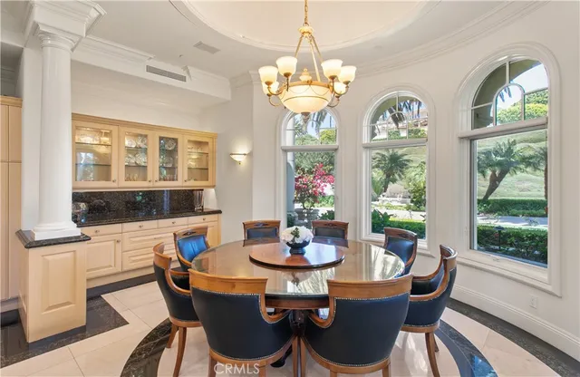 a dining room with furniture a large window and wooden floor