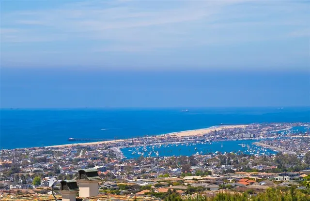 an aerial view of ocean and city