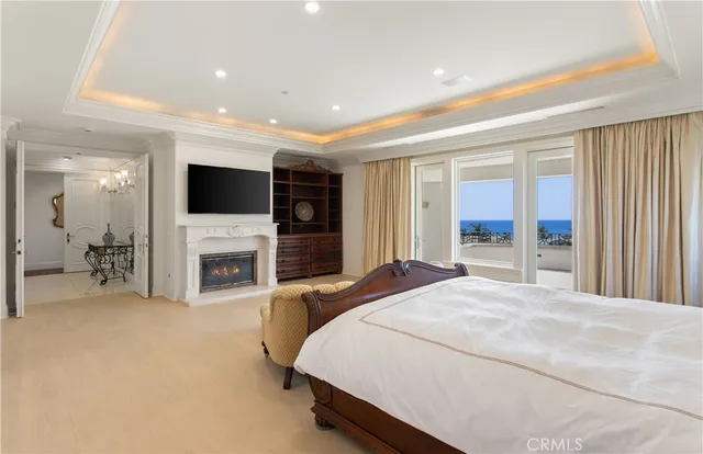 a spacious bedroom with a bed and a flat screen tv