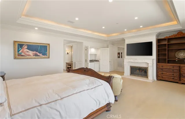 a spacious bedroom with a large bed and a fireplace