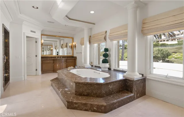 a spacious bathroom with a granite countertop sink mirror and bathtub