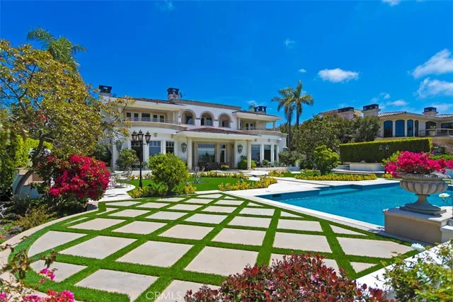 a view of a house with swimming pool and sitting area