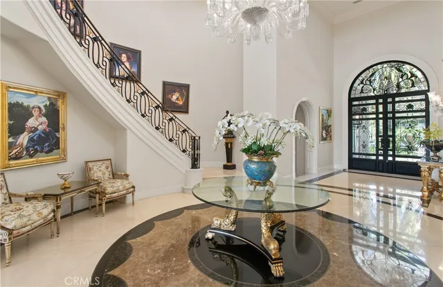 a dining room with wooden floor a chandelier a wooden table and chairs