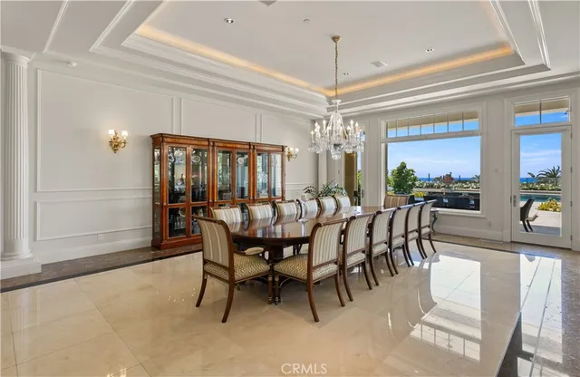 a dining room with furniture a chandelier and wooden floor