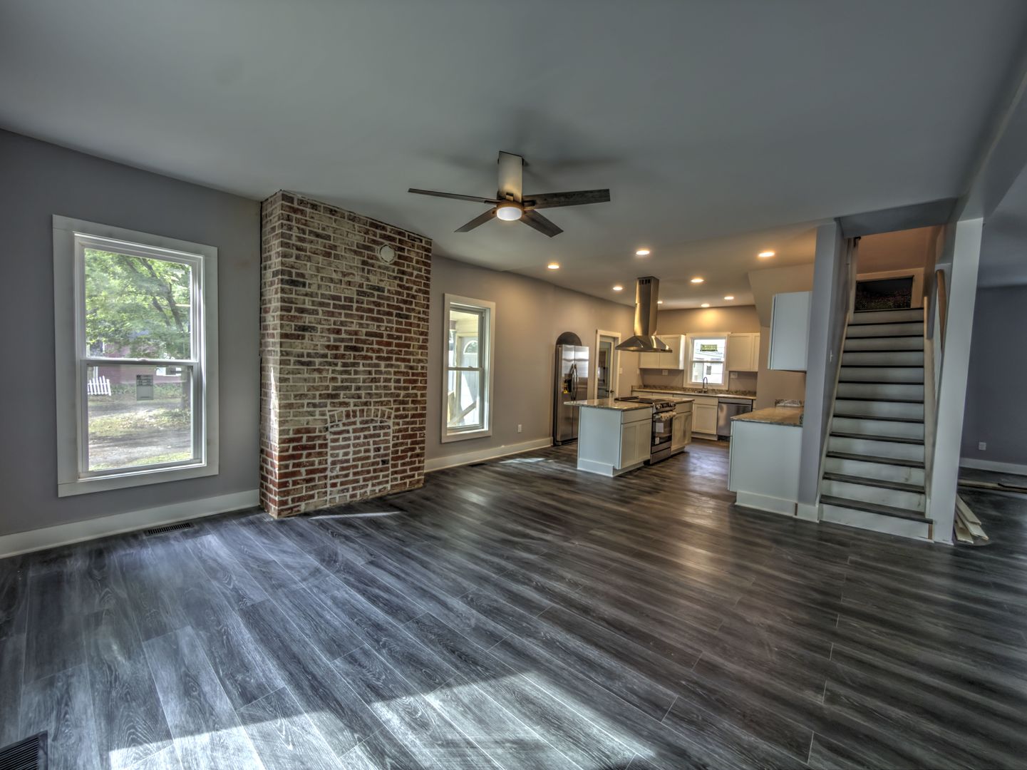 623 South 4th Street Watseka, IL 60970 - Photo 20 of 35 an empty room with wooden floor kitchen view and a window