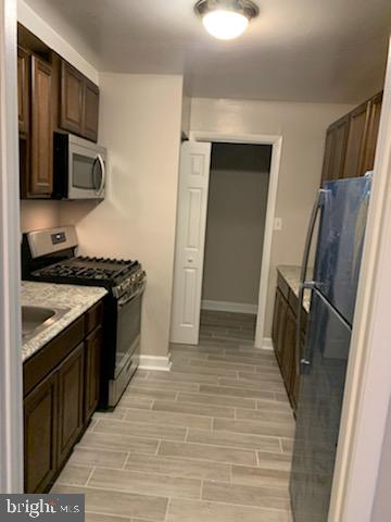 a kitchen with a sink stove and refrigerator