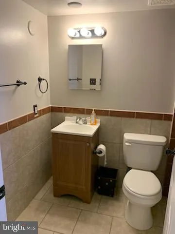 a bathroom with a sink a toilet and mirror