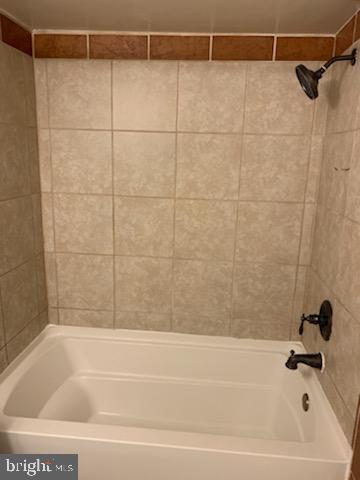 3823 St Barnabas Road, Unit T2 Suitland, MD 20746 - Photo 3 of 11 a bathroom with a shower and a bathtub