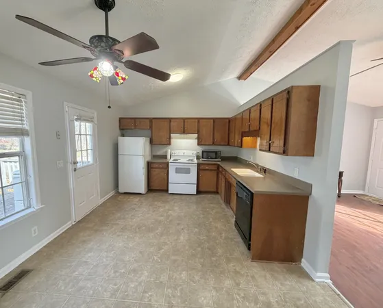 a kitchen with stainless steel appliances granite countertop a stove and a refrigerator