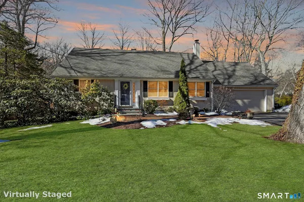 a view of a house with swimming pool and sitting area