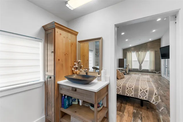 a bedroom with furniture and a window