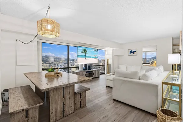a living room with furniture and a wooden floor