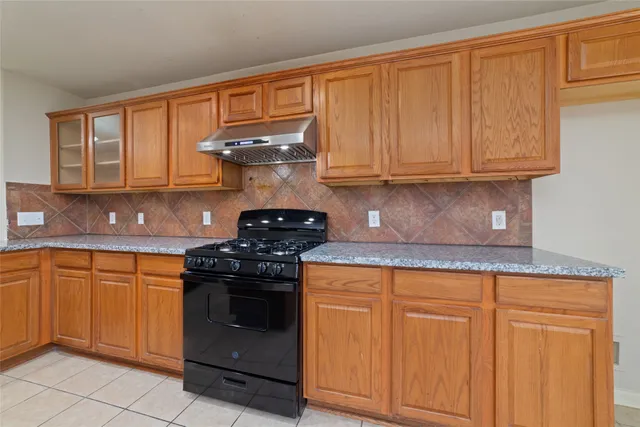 a kitchen with stainless steel appliances granite countertop a sink stove and cabinets