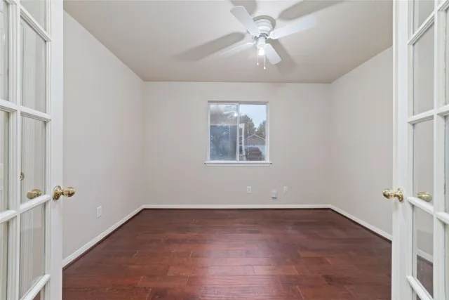 wooden floor in an empty room with a window