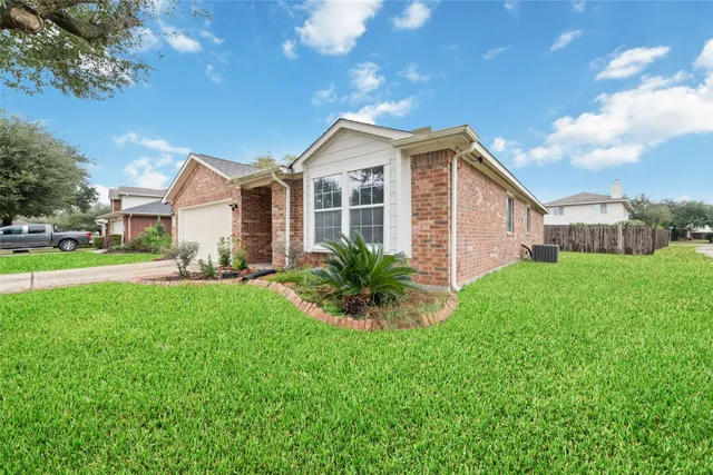 a front view of house with a garden