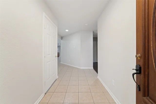 an empty room with windows and fireplace