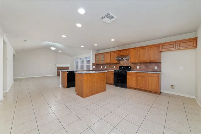 a kitchen with granite countertop cabinets and stainless steel appliances