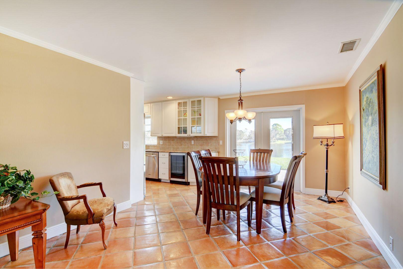 9989 Liberty Road Boca Raton, FL 33434 - Photo 9 of 44 a view of a dining room with furniture and window