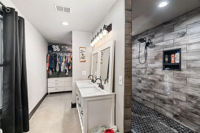 a bathroom with a sink a mirror and shower
