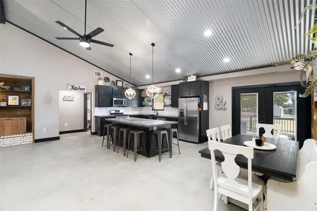 a large kitchen with a table and chairs