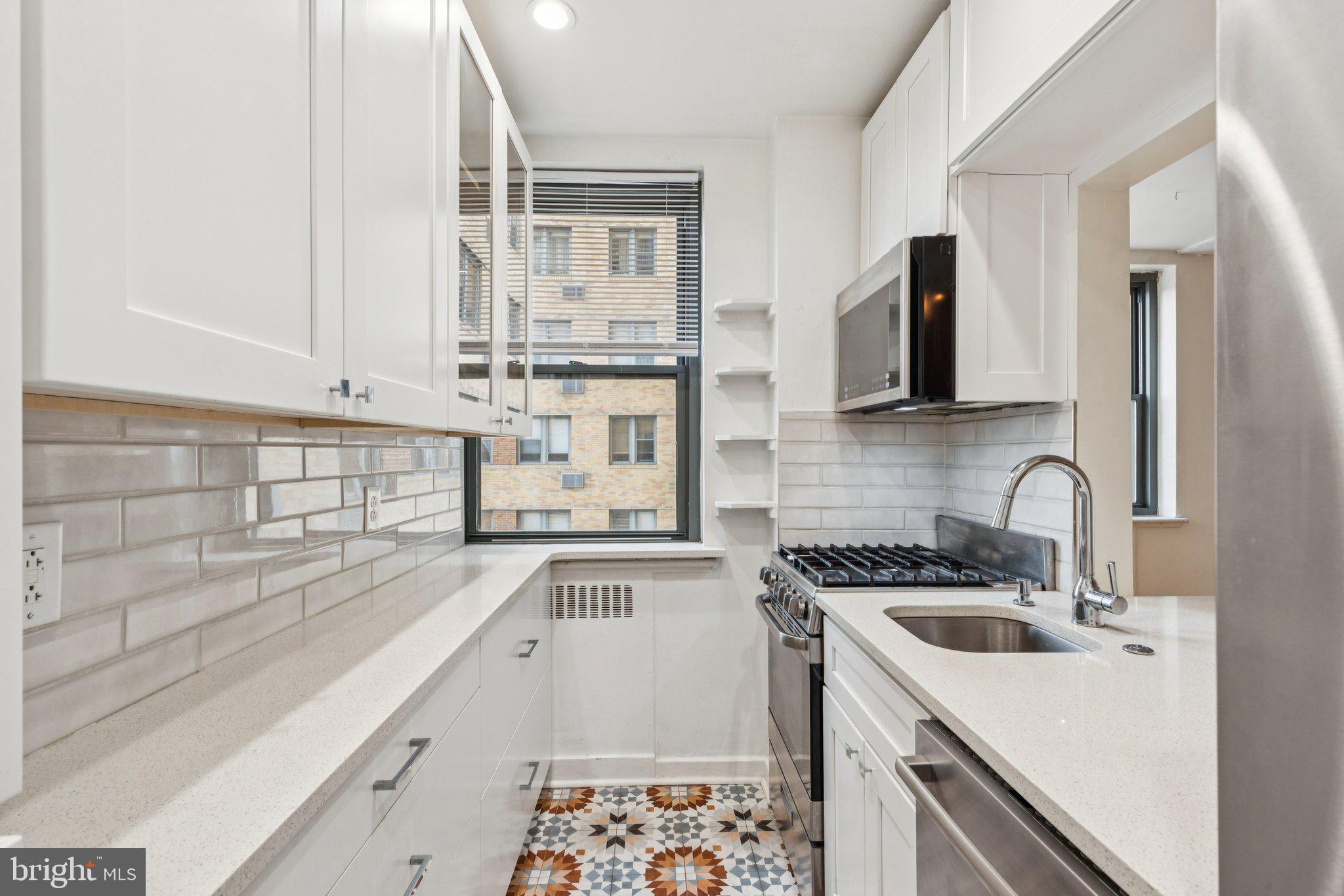 2601 Pennsylvania Avenue, Unit 449 Philadelphia, PA 19130 - Photo 1 of 18 a kitchen with a sink stove top oven and refrigerator