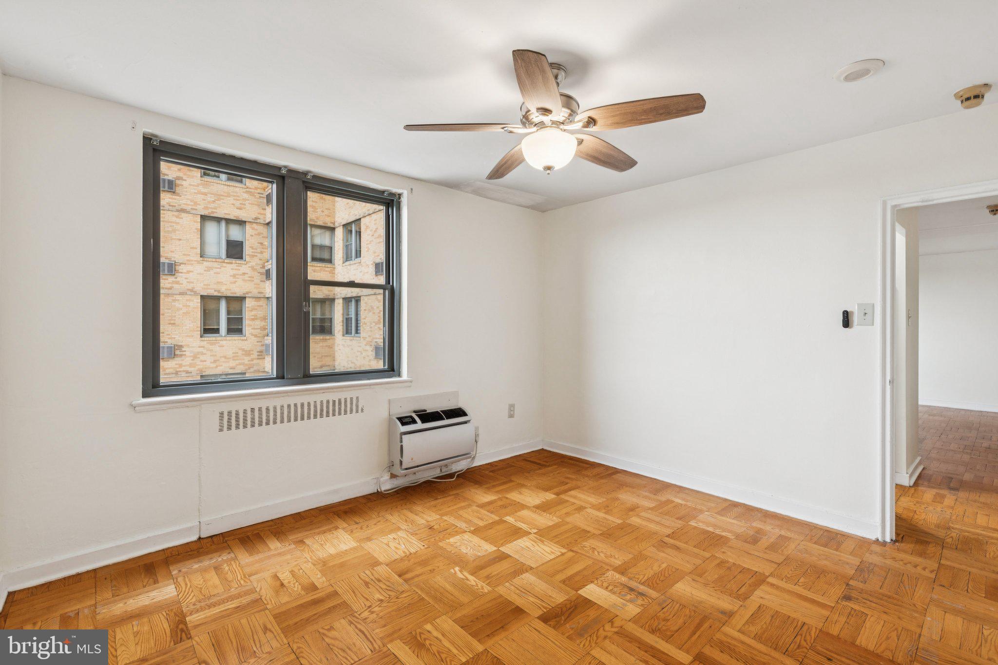2601 Pennsylvania Avenue, Unit 449 Philadelphia, PA 19130 - Photo 13 of 18 a view of an empty room with chandelier fan and fire place