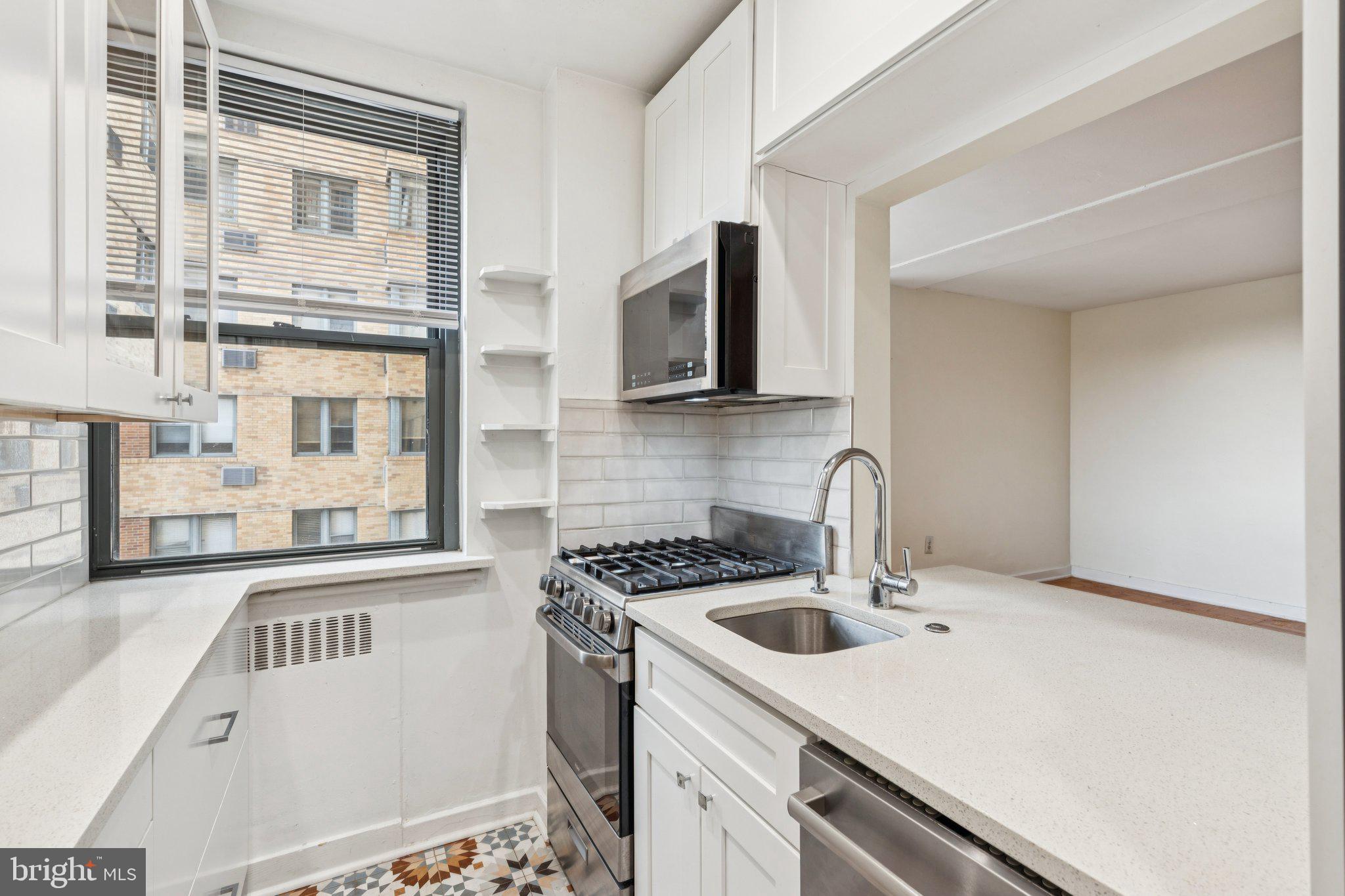 2601 Pennsylvania Avenue, Unit 449 Philadelphia, PA 19130 - Photo 2 of 18 a kitchen with stainless steel appliances granite countertop a sink and a stove top oven
