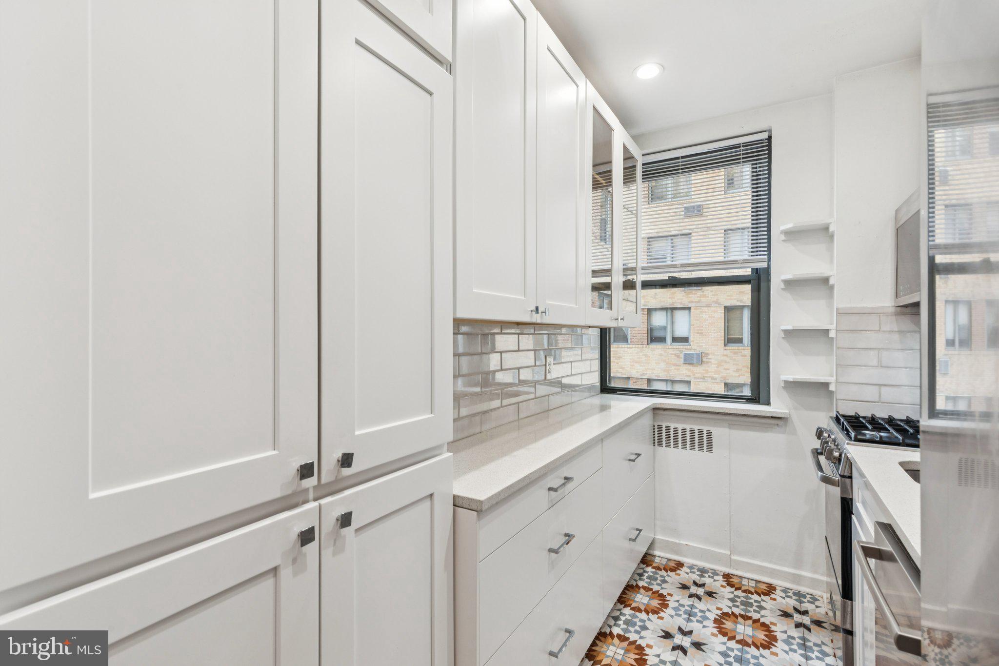 2601 Pennsylvania Avenue, Unit 449 Philadelphia, PA 19130 - Photo 3 of 18 a kitchen with stainless steel appliances a sink and cabinets