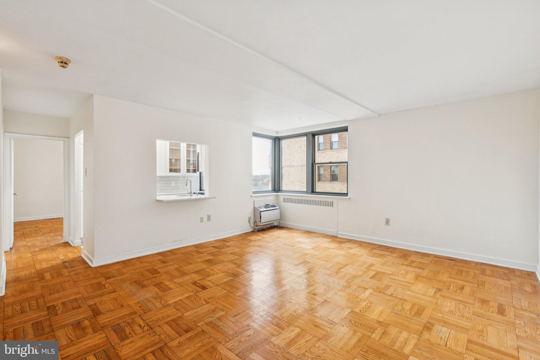 2601 Pennsylvania Avenue, Unit 449 Philadelphia, PA 19130 - Photo 6 of 18 a view of an empty room with wooden floor and a window