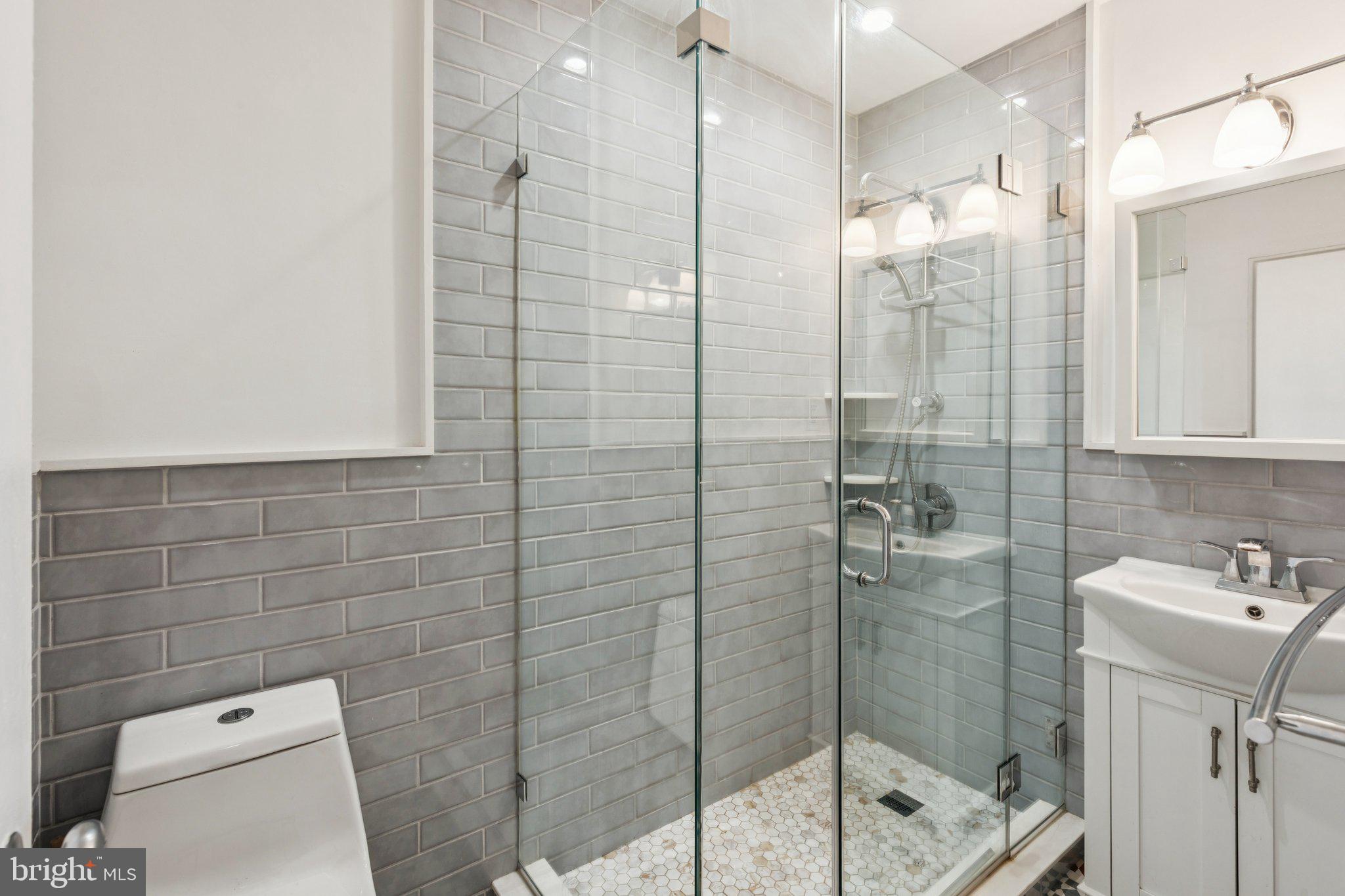 2601 Pennsylvania Avenue, Unit 449 Philadelphia, PA 19130 - Photo 10 of 18 a bathroom with a shower a toilet and sink