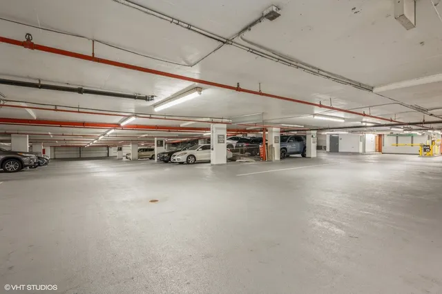 a view of parking garage with cars parked