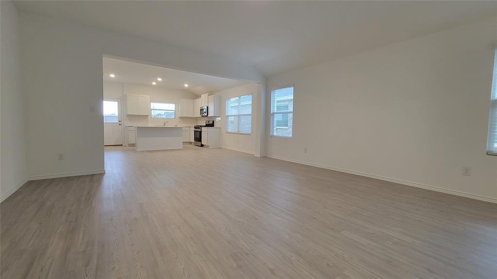 587 Avre Loop Kyle, TX 78640 - Photo 16 of 20 a view of empty room with wooden floor and fireplace