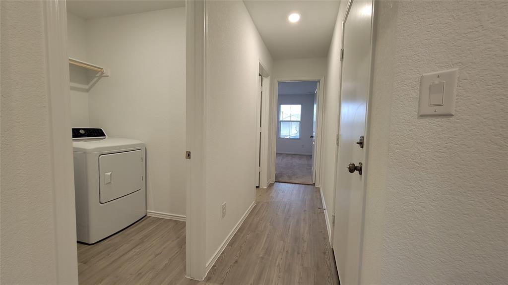 587 Avre Loop Kyle, TX 78640 - Photo 17 of 20 a view of a hallway with wooden floor
