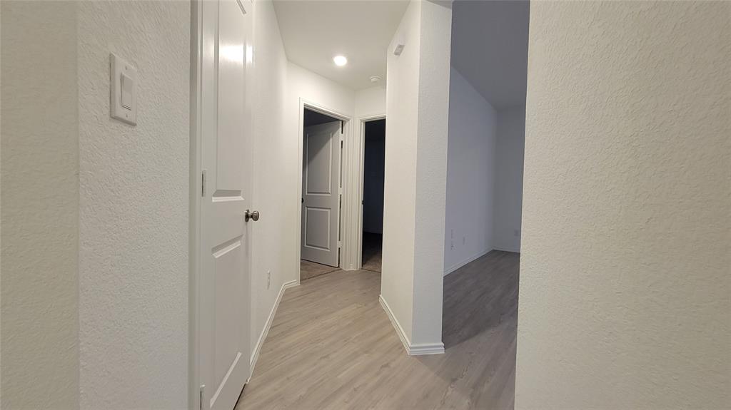 587 Avre Loop Kyle, TX 78640 - Photo 18 of 20 a view of hallway with closet and wooden floor