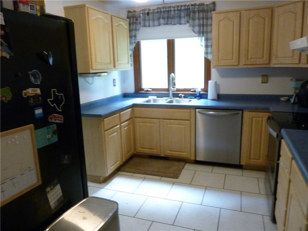 901 Prospect Road Evans City, PA 16033 - Photo 3 of 12 a kitchen with stainless steel appliances granite countertop a sink and cabinets