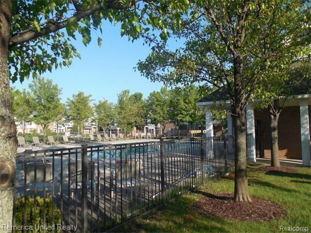 1109 Rial Lake Drive, Unit 47 Howell, MI 48843 - Photo 30 of 33 Summer view of the pool