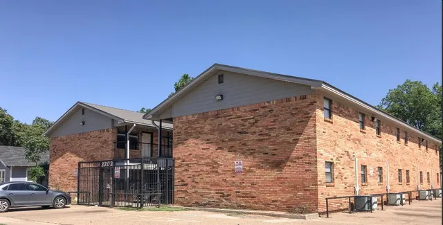 a front view of a residential apartment building with a street