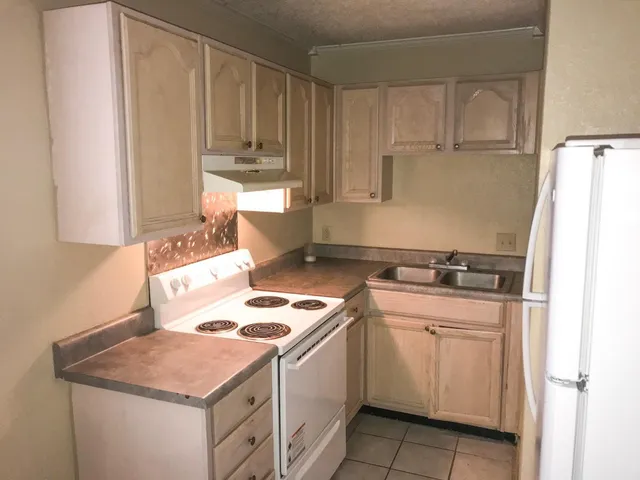 a kitchen with a stove and a refrigerator