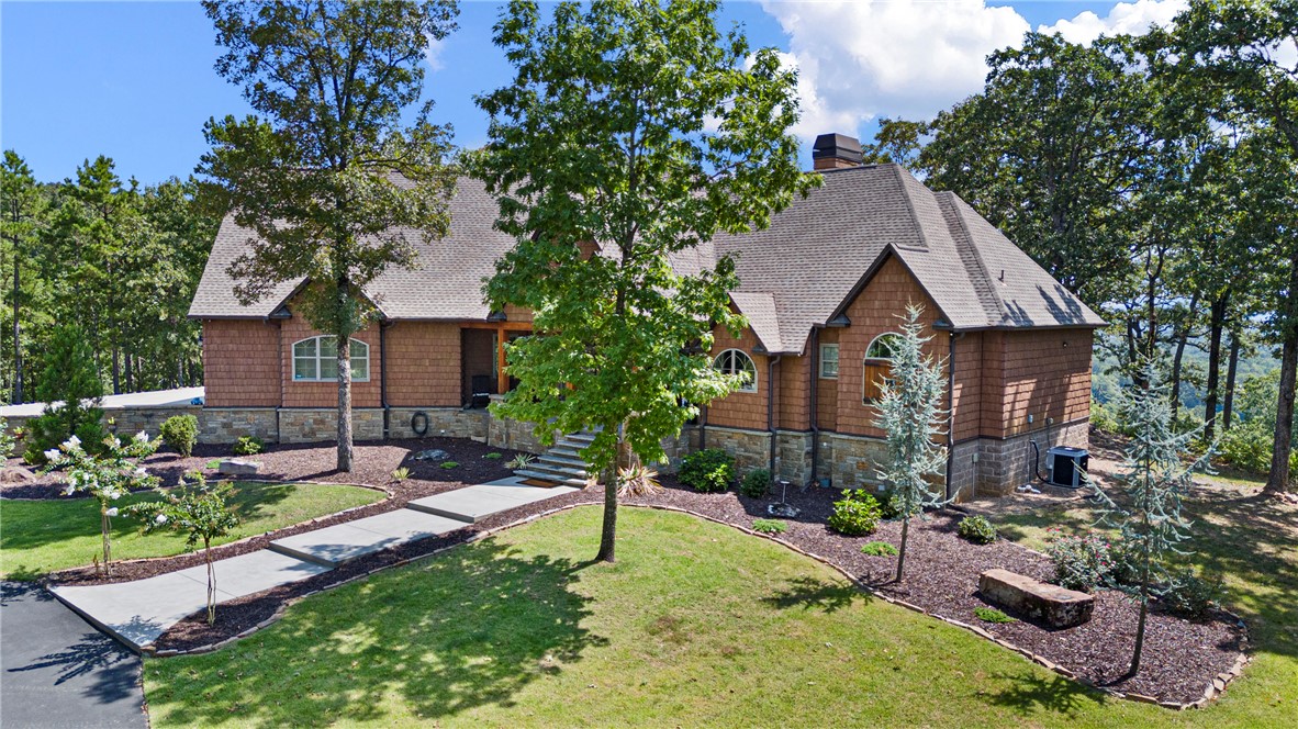 3419 Bailey Loop Road London, AR 72847 - Photo 60 of 60 Craftsman-style exterior featuring a blend of wood siding and stone, multi-pitched roofline, arched windows, and a paved walkway