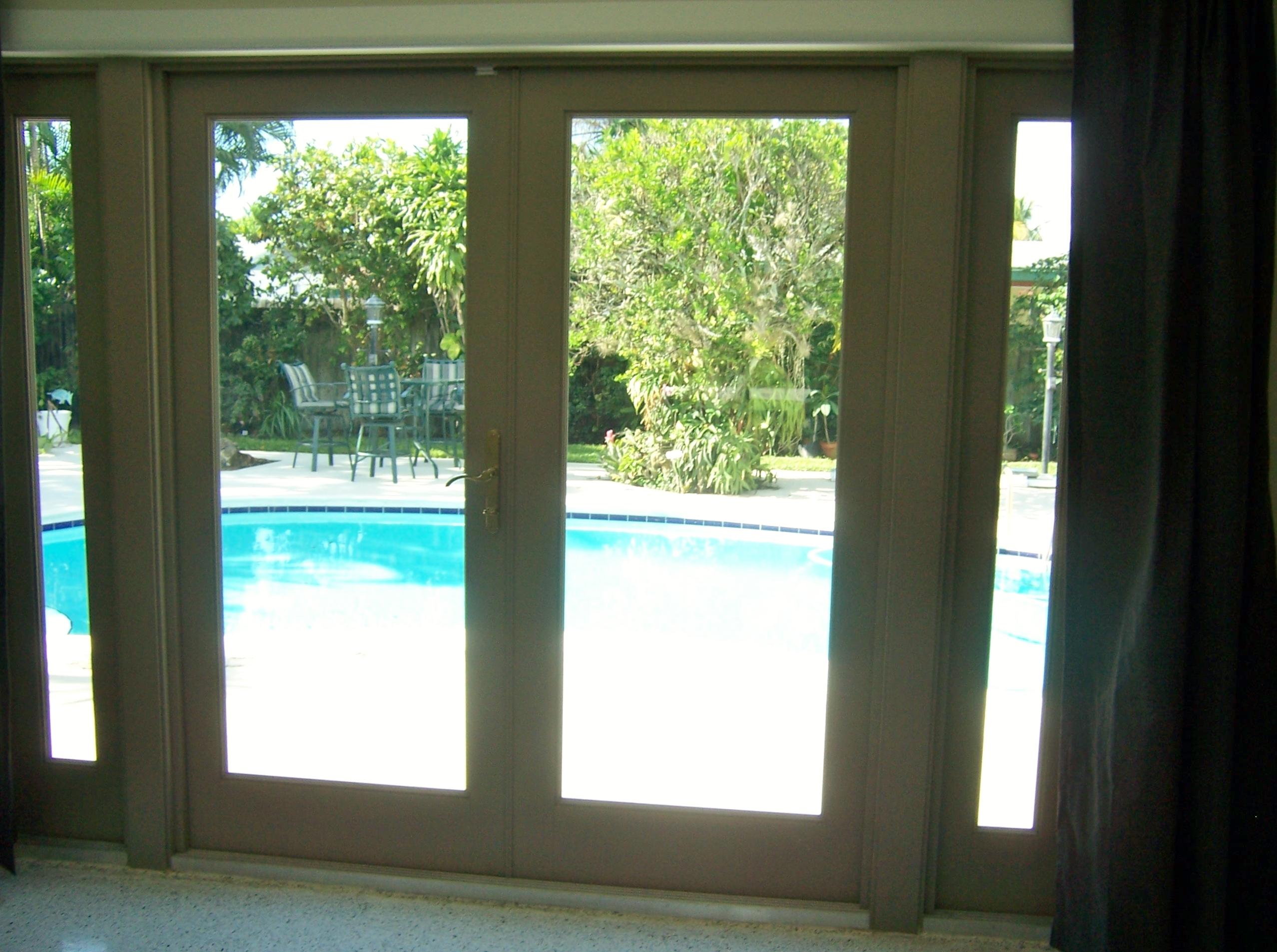 2664 Exuma Road West Palm Beach, FL 33406 - Photo 22 of 33 impact glass doors opening to pool area